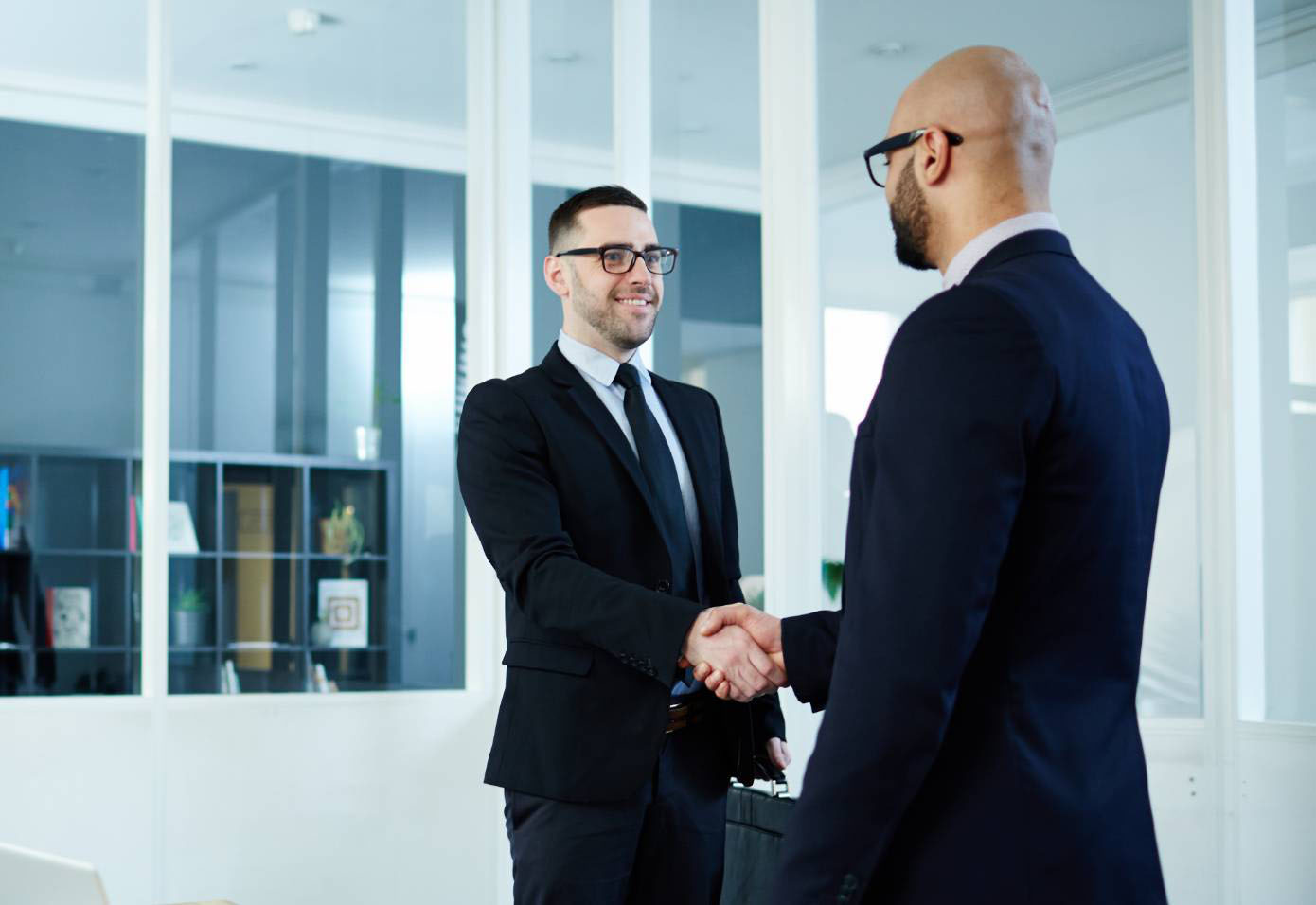 two professionally dressed men shaking hands