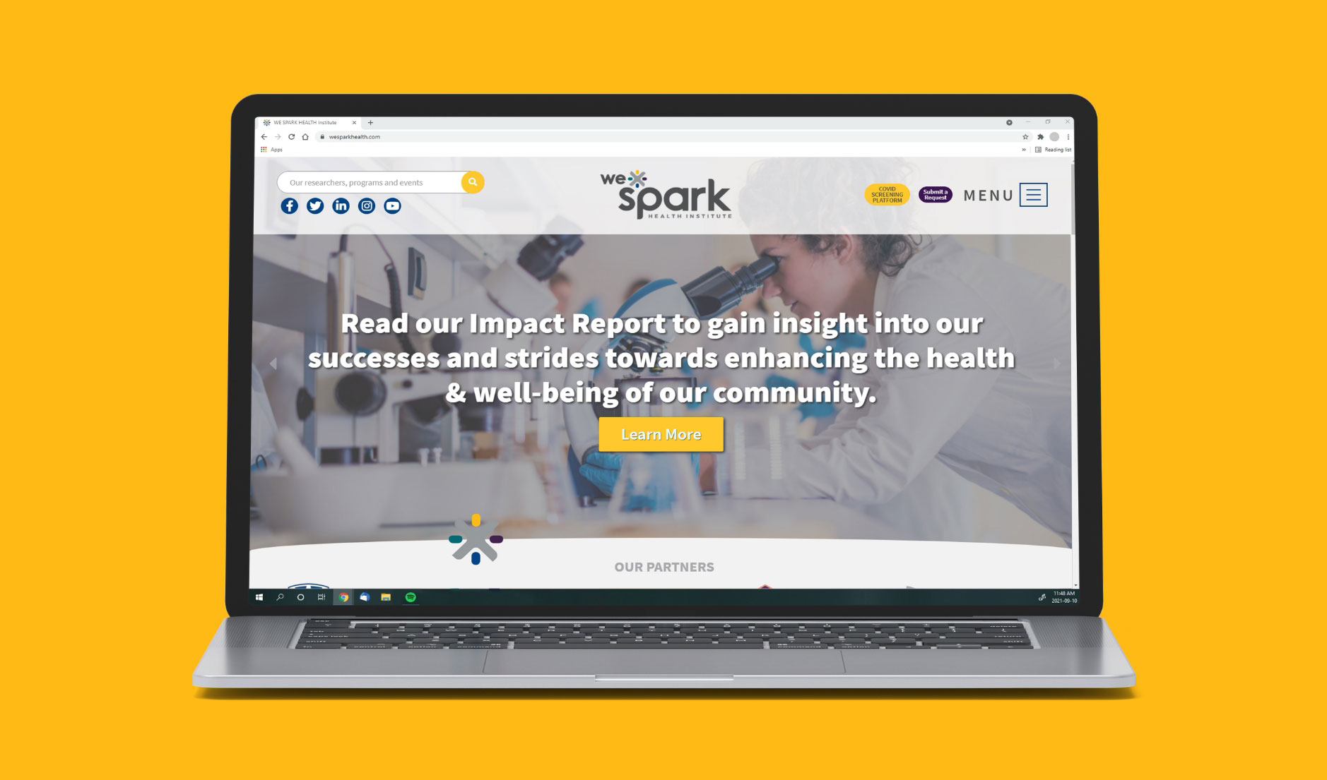 WE-SPARK homepage displayed on a laptop screen